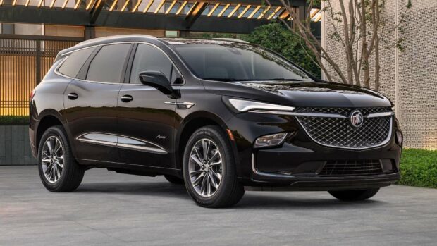 A sleek black Buick Enclave SUV is parked outdoors near modern architecture, HD Desktop Wallpaper