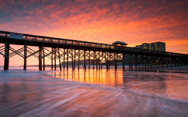 South Carolina Pier at Sunset Reflecting Vibrant Sky and Calm Ocean Waves Wallpaper
