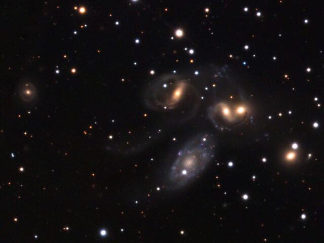 Spectacular View Of Stephans Quintet Galaxies In Space Wallpaper