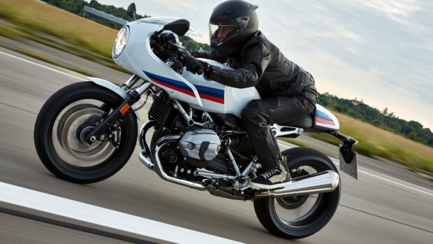 A rider in full gear drives a Bmw R Nine T motorcycle along a countryside road, 4K Desktop Wallpaper