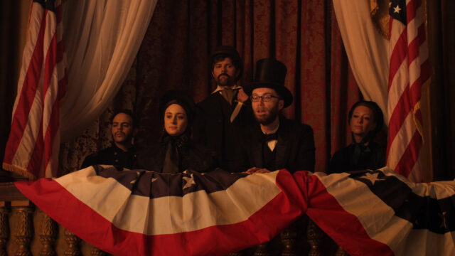 Stephen Merchant Historical Costume Drama Scene with American Flags Wallpaper