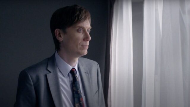 Stephen Merchant in a gray suit looking thoughtfully out of a window Stephen Merchant wallpapers