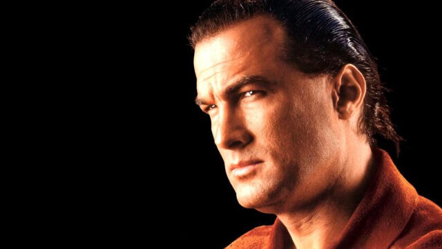 Steven Seagal Close Up Portrait Wallpaper with Intense Expression on Black Background