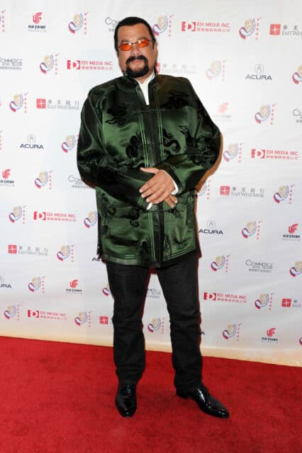 Steven Seagal wearing traditional jacket on red carpet at film event wallpaper