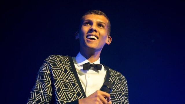 Stromae Wallpapers Stunning Close Up of Singer in Geometric Jacket and Bow Tie on Stage