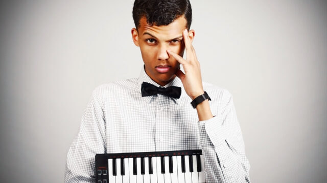 Stromae holding keyboard wearing bow tie stylish musician wallpapers