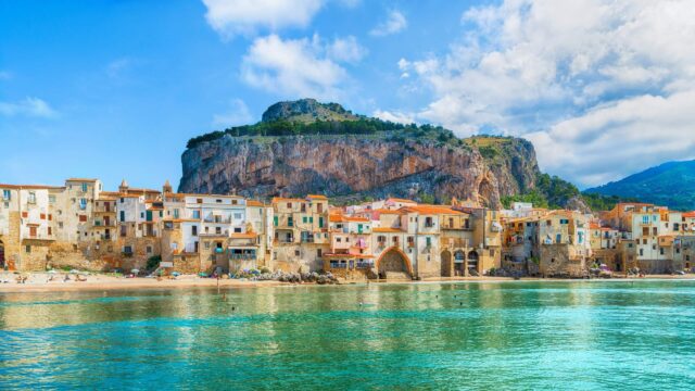Stunning Coastal View Of Cefalù With Historic Buildings And Clear Waters
