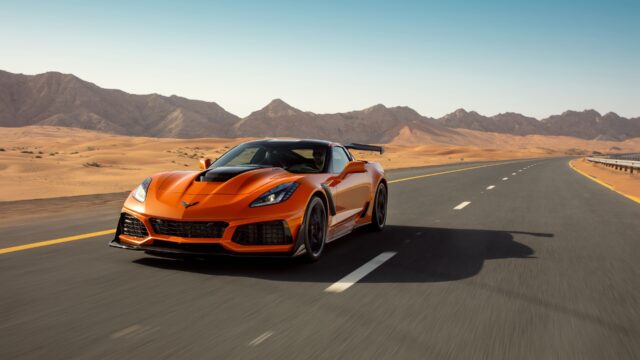Stunning Orange Chevrolet Corvette Driving On Desert Highway Beautiful Corvette Wallpapers