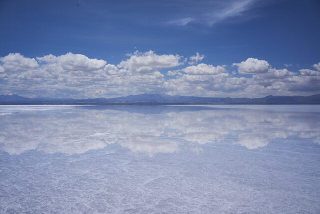 Stunning Salar De Uyuni Bolivia Wallpaper Reflecting Clouds and Blue Sky
