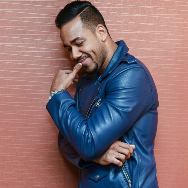 Stylish Blue Jacket Portrait Perfect for Romeo Santos Wallpapers