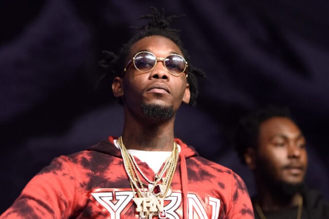 Stylish Offset Rapper Wearing Red Hoodie and Gold Chains in High Quality Wallpaper