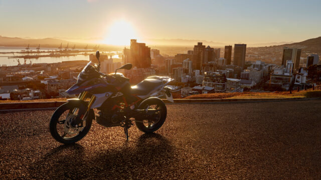 Sunset Adventure With BMW G 310 GS In Cityscape Wallpaper