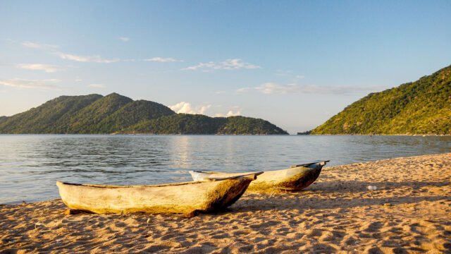 Sunset Tranquility On Lake Malawi With Wooden Canoes