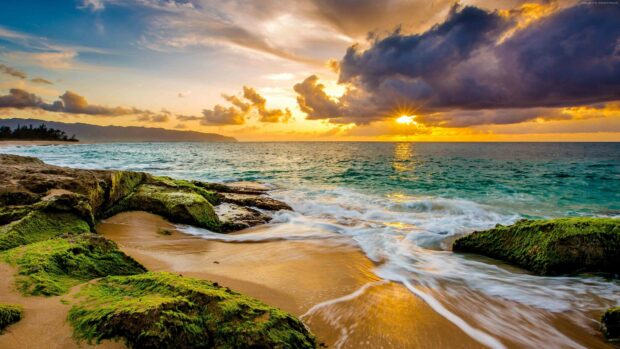 The sun sets over a moss covered rocky shore with waves in Dominica, 4K Desktop Wallpaper