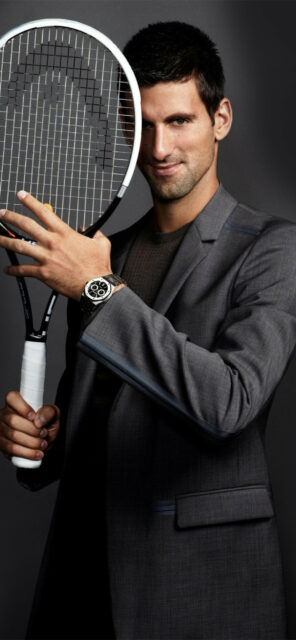 Tennis Legend In Stylish Suit With Racket   Novak Djokovic Wallpaper