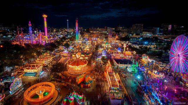 Texas Desktop Background HD, A Vibrant And Colorful Depiction Of The Texas State Fair With Carnival Rides And Festive Lights