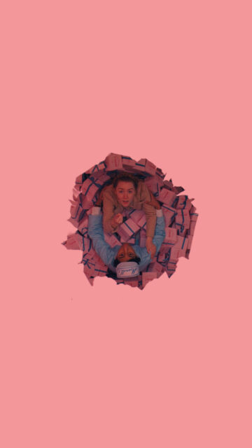 The Grand Budapest Hotel Inspired Scene with Characters Among Pink Boxes Wallpaper