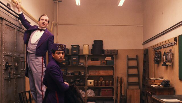 The Grand Budapest Hotel Lobby Boy and Concierge in Vintage Storage Room Wallpaper