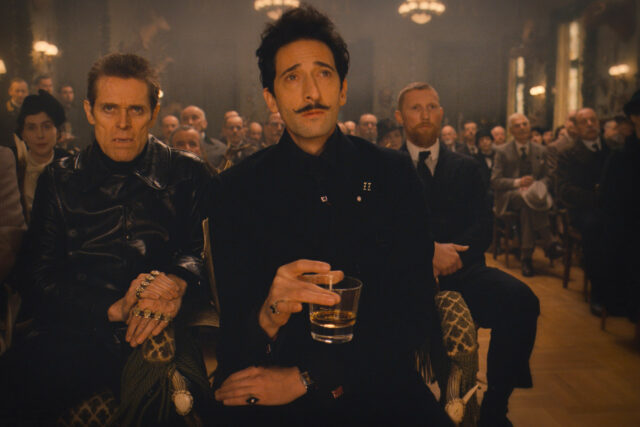 The Grand Budapest Hotel Movie Scene with Characters in Formal Attire Holding Drink