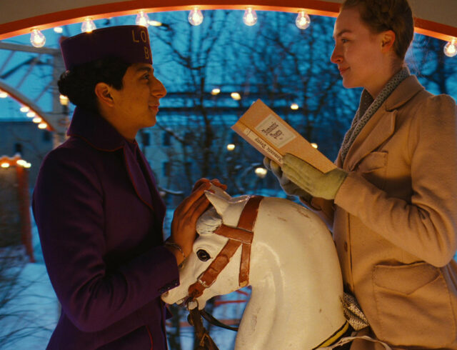 The Grand Budapest Hotel Scene with Characters on Carousel Horse at Dusk Wallpapers