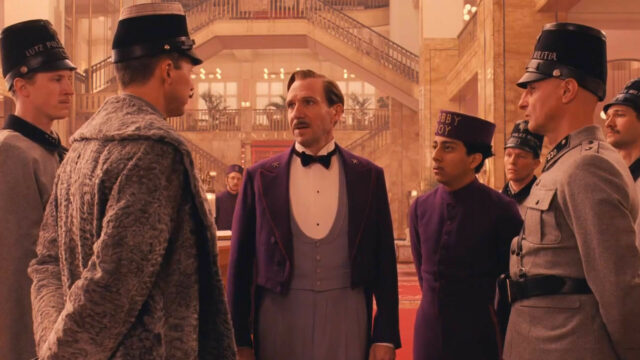 The Grand Budapest Hotel Scene with Lobby Boy and Police Inside Elegant Lobby