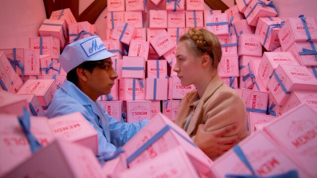 The Grand Budapest Hotel Scene with Pink Mendl’s Boxes and Characters Facing Each Other