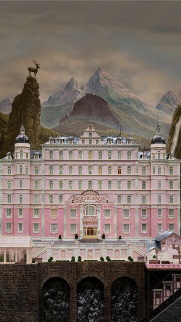 The Grand Budapest Hotel Scenic Mountain View Wallpaper with Deer Statue and Waterfall