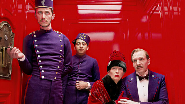 The Grand Budapest Hotel Wallpaper Featuring Main Characters in Purple Uniforms and Red Background