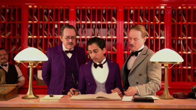 The Grand Budapest Hotel staff checking the guest register at the front desk wallpaper