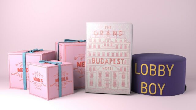 The Grand Budapest Hotel themed Mendl’s pink boxes and lobby boy hat wallpaper