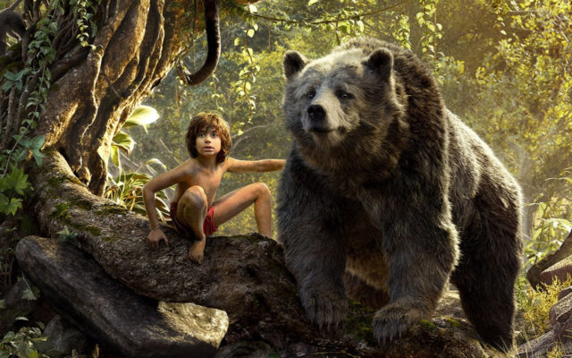 The Jungle Book Movie Wallpaper Featuring Mowgli and Baloo in the Jungle Forest