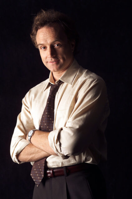 The West Wing TV Series Wallpaper Featuring Character in Classic Office Attire