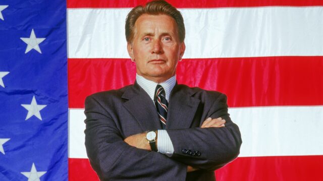 The West Wing TV Series Wallpaper President Standing Confidently in Front of American Flag
