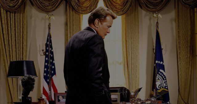 The West Wing TV Series Wallpaper President Standing in Oval Office with Flags and Desk