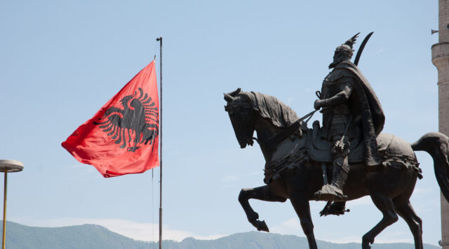 Tirana Albania Iconic Monument And Flag Wallpaper