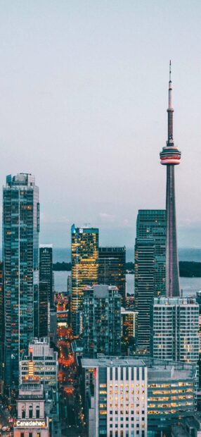 The CN Tower stands tall among city buildings in Canada during dusk, HD Mobile Wallpaper
