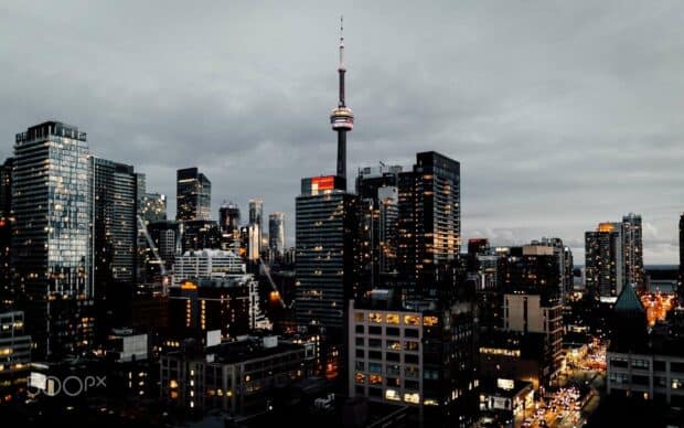 The CN Tower in Canada stands tall amidst city buildings at dusk, HD Desktop Wallpaper