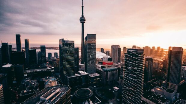 A stunning view of the CN Tower Canada illuminates the city skyline during sunset, HD Desktop Wallpaper