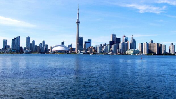 The Toronto skyline includes the iconic CN Tower standing tall amidst modern skyscrapers