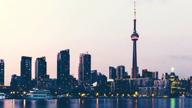 The Toronto skyline features the CN Tower illuminated at dusk over the water, HD Desktop Wallpaper