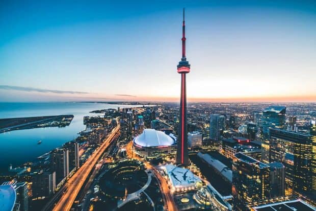 The CN Tower in Canada towers over the city skyline during sunset, HD Desktop Wallpaper