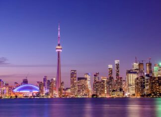 The Toronto skyline features the iconic CN Tower illuminated against a purple sky, HD Desktop Wallpaper