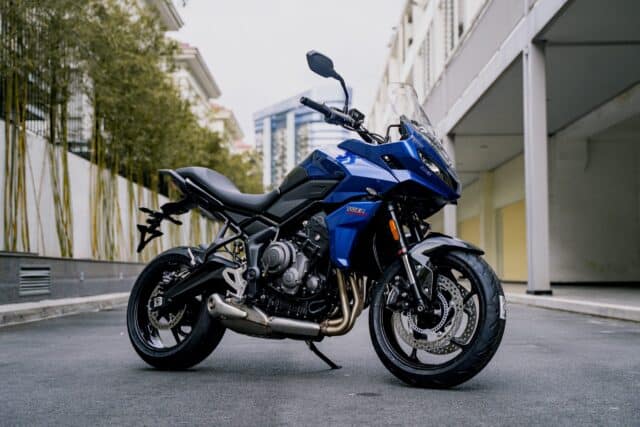 Triumph Tiger Sport 660 Blue Motorcycle Parked on Urban Street Wallpaper