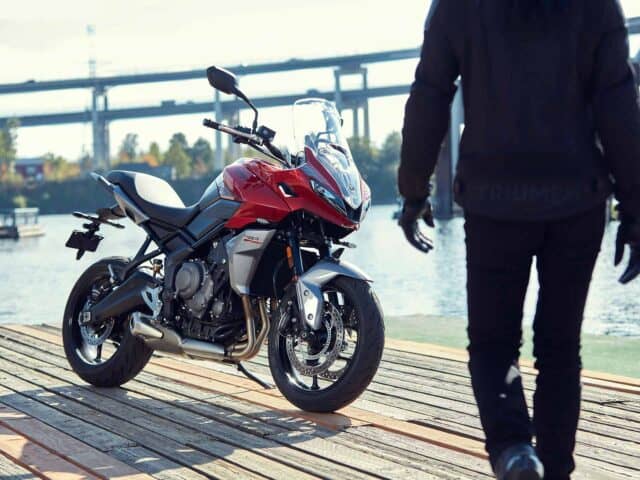 Triumph Tiger Sport 660 Motorcycle Parked on Wooden Dock Near Water