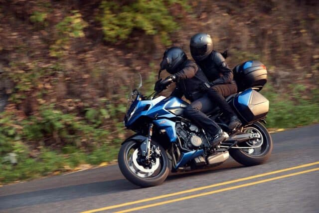 Triumph Tiger Sport 660 Motorcycle Riding Adventure on Scenic Road Wallpaper