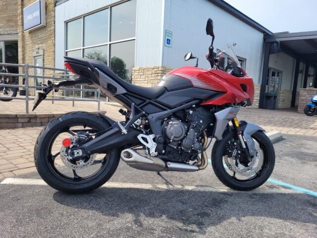 Triumph Tiger Sport 660 Red Motorcycle Side View Wallpaper in Urban Setting