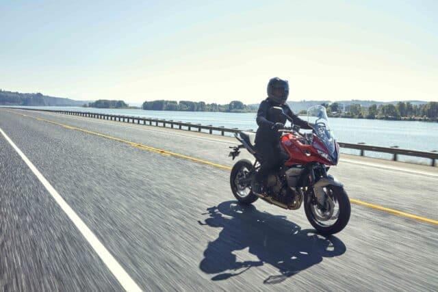 Triumph Tiger Sport 660 Riding Along Scenic Lakeside Road Wallpaper