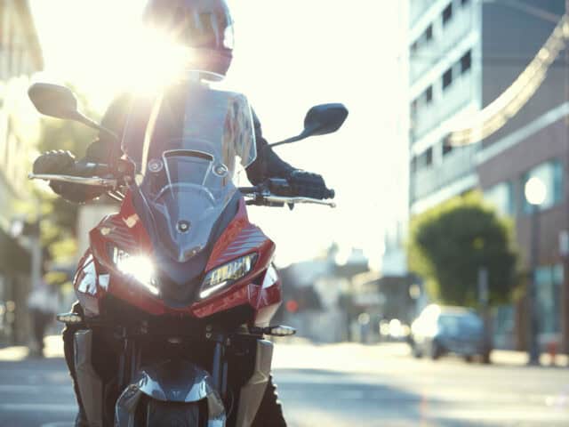 Triumph Tiger Sport 660 Riding in Urban Street Light with Stunning Wallpaper View