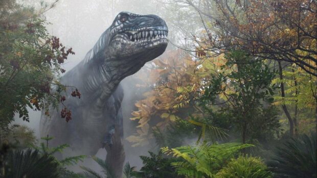 A large Tyrannosaurus rex stands surrounded by dense foliage and mist in a prehistoric jungle scene from Ark Survival Evolved wallpapers
