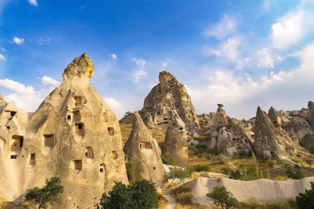 Cappadocia features unique rock formations with natural caves and blue skies, HD Desktop Wallpaper